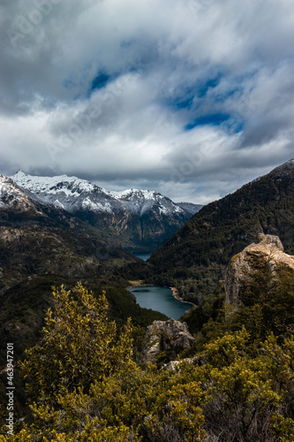 A small lake between mountains and forests