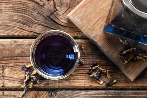 Glass of butterfly pea flower tea on table