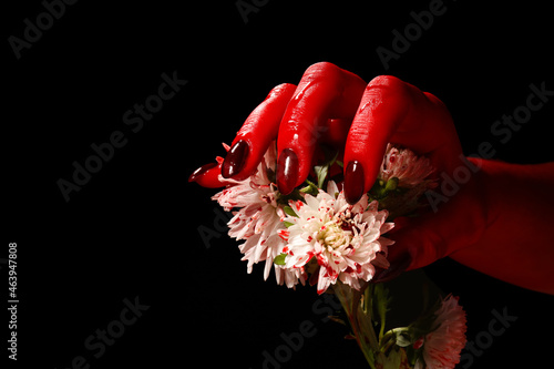 Hand and flowers covered wi...