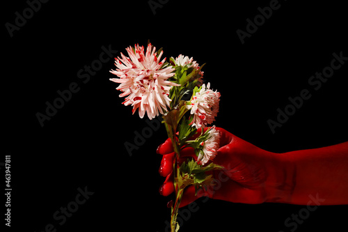 Hand and flowers covered wi...