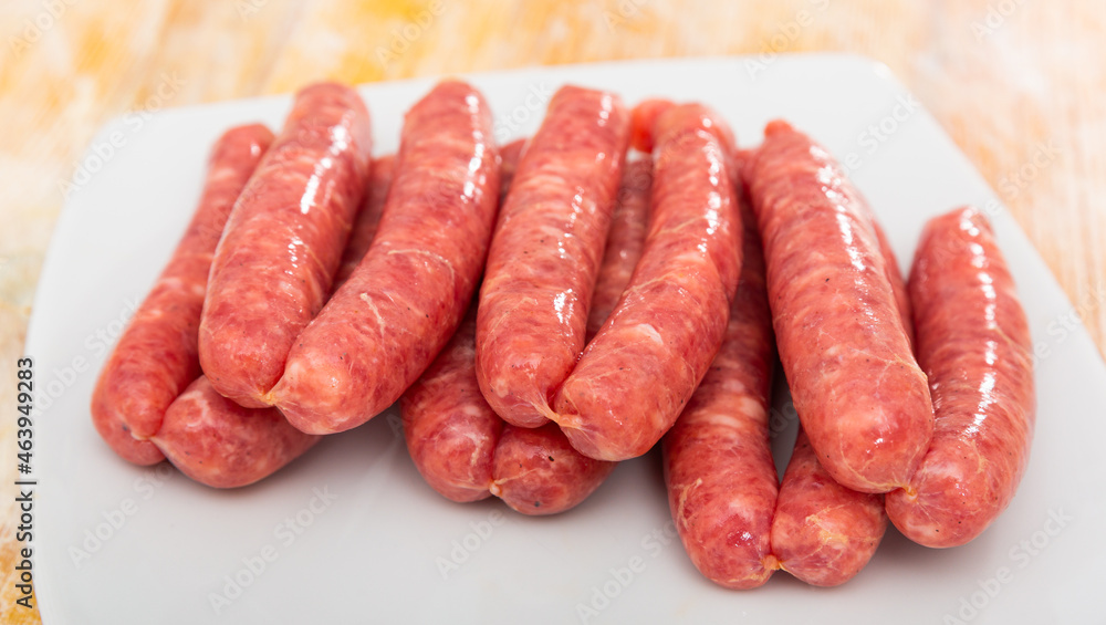 Closeup of uncooked pork meat sausage on a plate, traditional german cuisune