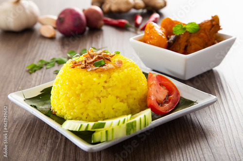 Nasi Kunyit also known as Turmeric Glutinous Rice. Normally eaten with dry curry chicken. photo