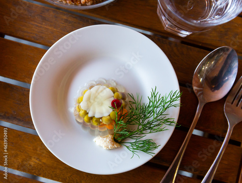 Meat aspic with green peas and carrot, typical dish of Russian cuisine kholodets photo