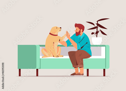 young man spending time with dog male owner and cute domestic animal friendship with pet concept