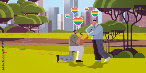 gay proposing to man down on knee with engagement ring transgender love LGBT community concept