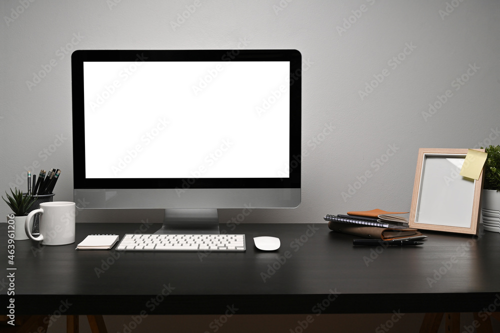 Mock up computer with blank screen, coffee cup and picture frame on black table. Mock up computer with blank screen, coffee cup and picture frame on black table.