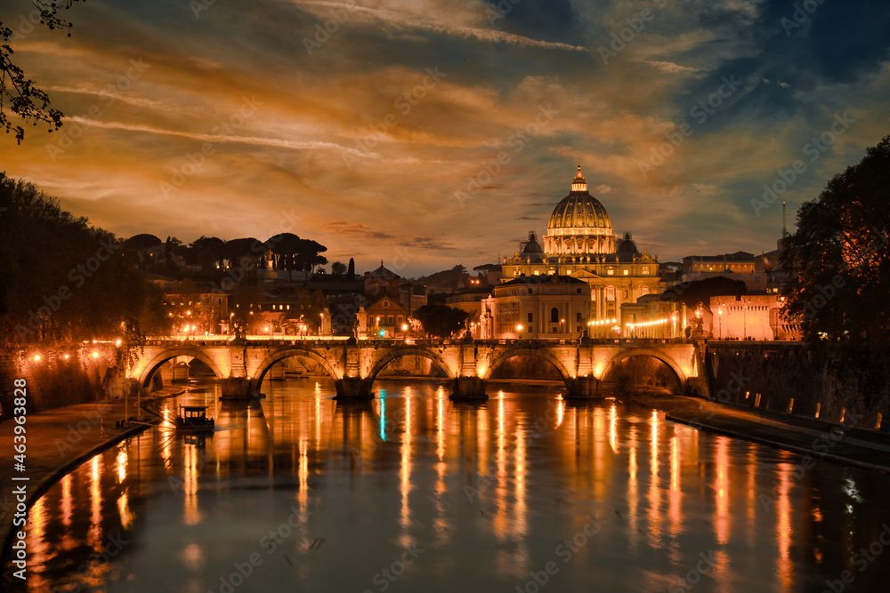 night view of Saint Angelo Bridge over the Tiber River with the St. Peter's Basilica in the background in Vatican Rome, Italy. Travel and vacation in Italy. landmarks of rome