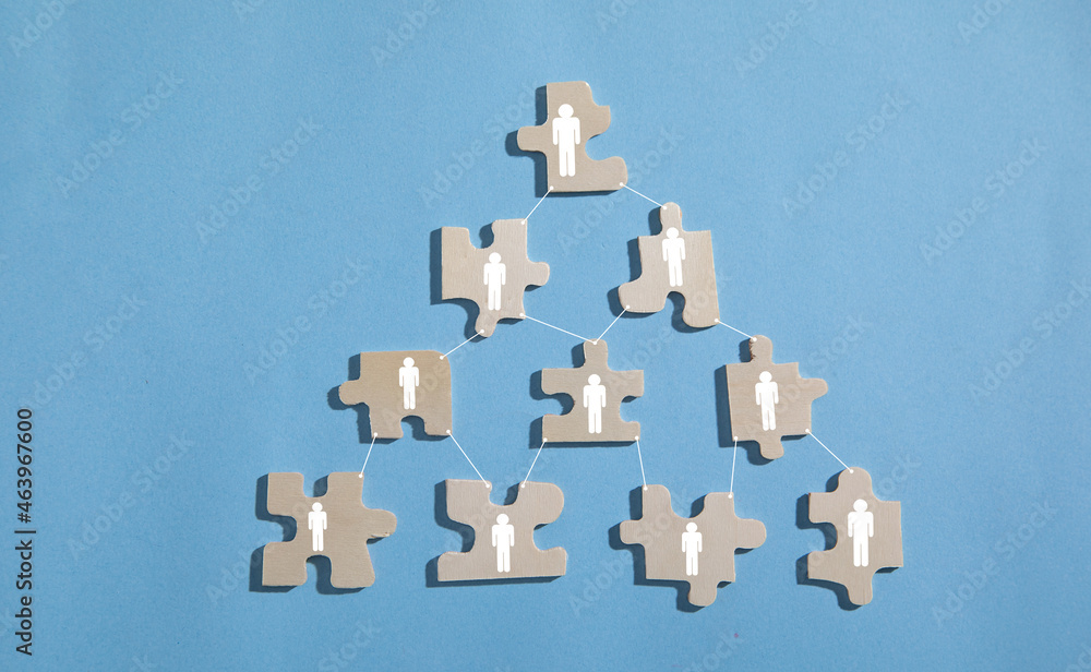 Naklejka premium Human icons on jigsaw puzzle. Teamwork
