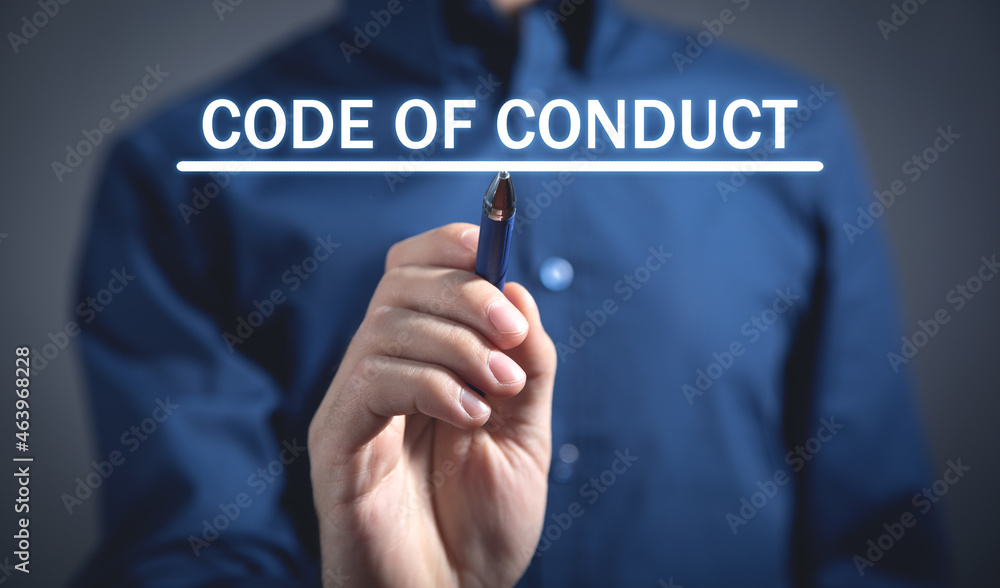 Man writes Code Of Conduct text in screen. Man writes Code Of Conduct text in screen.