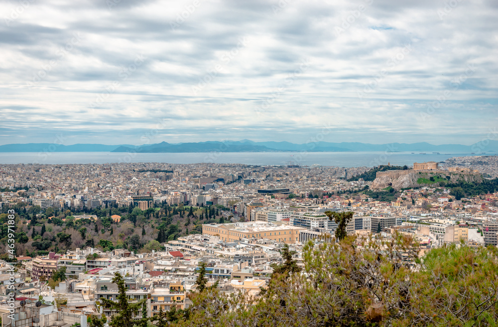 Panoramic view of Athens from Lycabettus Hill. From left to right, the National Garden, the Greek Parliament and the Acropolis. Faliron, Piraeus and the Saronic Gulf are in the background.