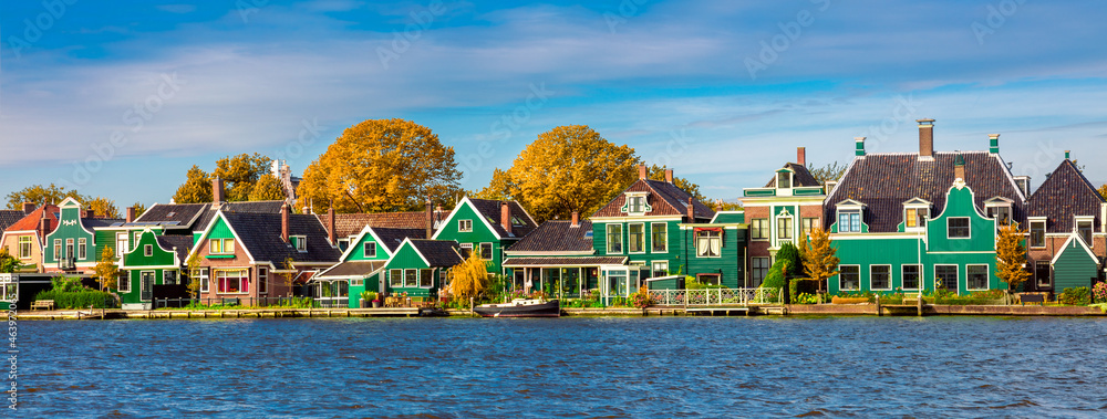 Dutch village Zaanse Schans near Amsterdam. Typical Dutch wooden green houses. Holland, Netherlands - obrazy, fototapety, plakaty 