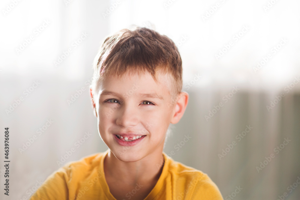 portrait of a smiling boy whose front milk teeth fell on a white background
portrait of a smiling boy whose front milk teeth fell on a white background