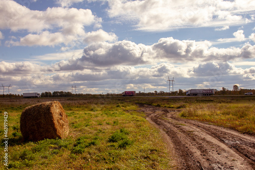 The road through the autumn fields. The dirt road winds through the autumn fields with mown hay © Илья Юрукин