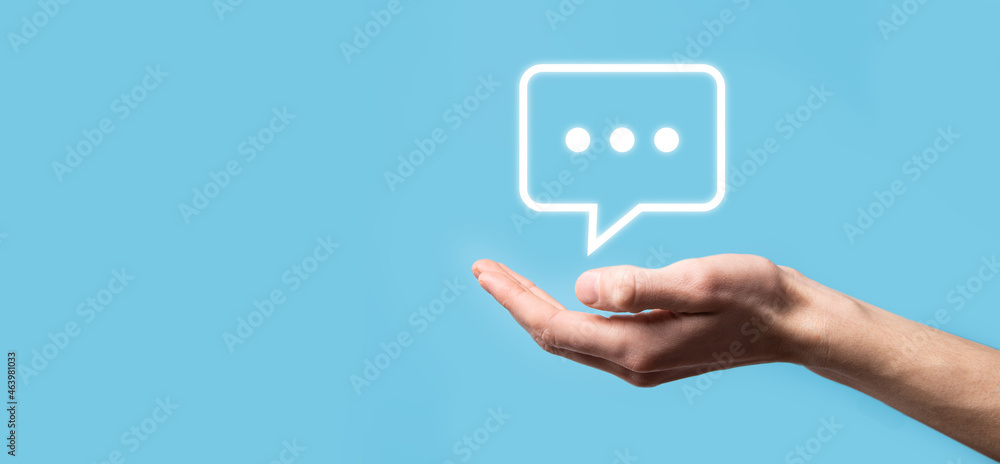 Businessman holding a message icon, bubble talk notification sign in his hands. Chat icon, sms icon, comments icon, speech bubbles Businessman holding a message icon, bubble talk notification sign in his hands. Chat icon, sms icon, comments icon, speech bubbles