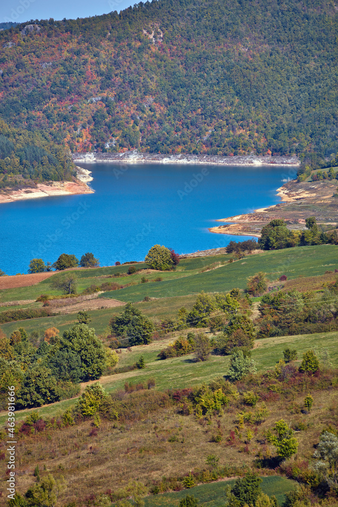 View of countryside lake Rovni, Serbia and hilly landscape in autumn colors.