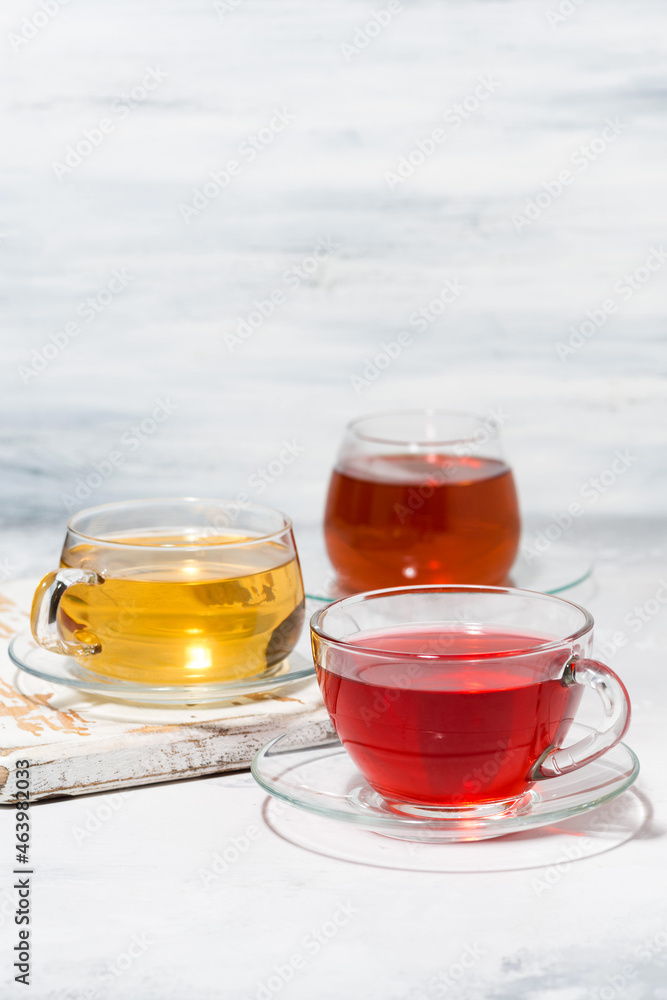 assortment of tea in glass cups on white background, vertical assortment of tea in glass cups on white background, vertical