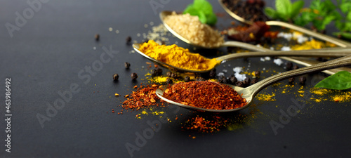 Dry chilli - spicy herbs for cooking and herbs on black background