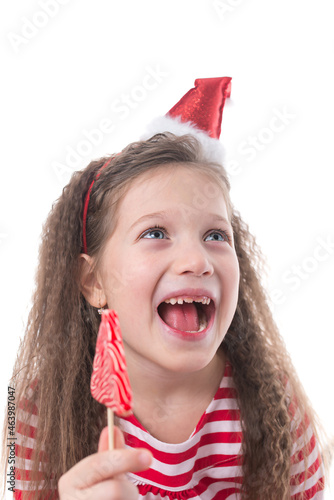 crazy look of a beautiful girl to the side with a candy Christmas tree in her hands, portrait
