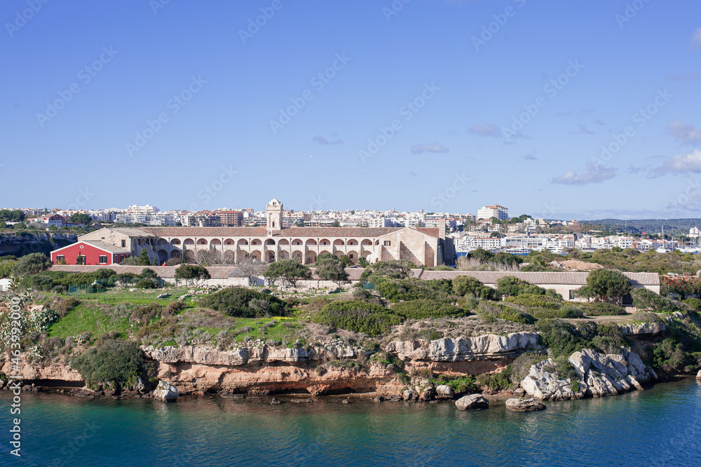 Fototapeta premium L'Illa del Rei Hospital Island in the middle of the main navigable entry channel to Mahon in Menorca in the Mediterranean Sea