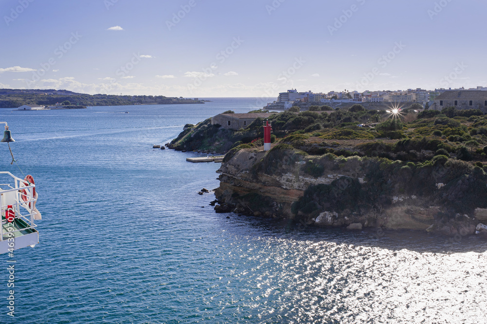 red lighthouse on L'Illa del Rei Hospital Island in the middle of the main navigable entry channel to Mahon in Menorca in the Mediterranean Sea red lighthouse on L'Illa del Rei Hospital Island in the middle of the main navigable entry channel to Mahon in Menorca in the Mediterranean Sea
