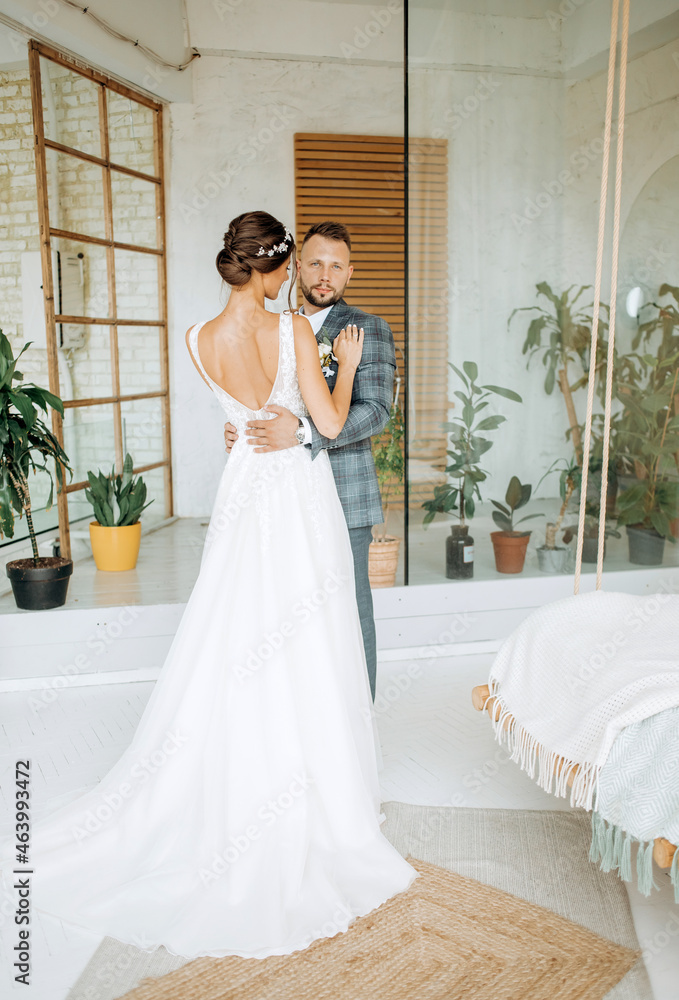 The newlyweds are posing in a beautiful room The newlyweds are posing in a beautiful room