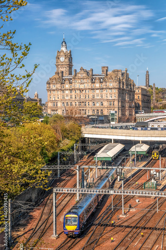 Edinburgh Waverley railway station with trains against Clock Tower building in Scotland, United Kingdom photo