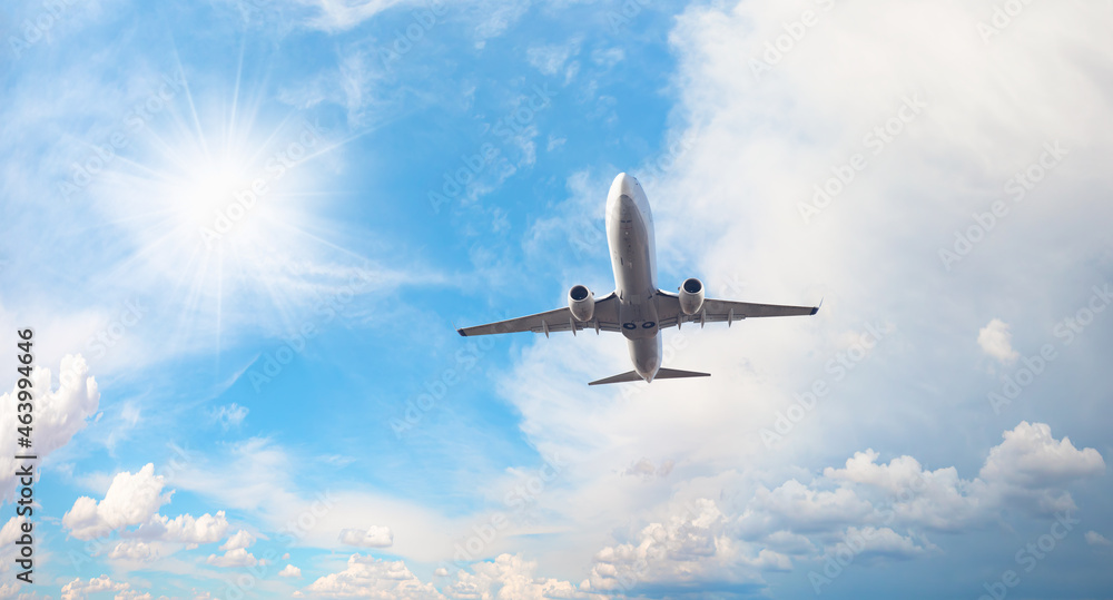 White passenger airplane over the clouds - Travel by air transport White passenger airplane over the clouds - Travel by air transport