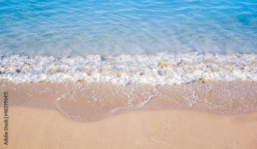 Ocean wave on sandy beach background © tendo23