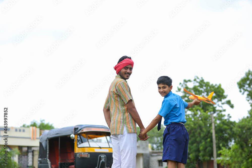 Indian auto rikshaw or tuk tuk driver with his schoolboy Indian auto rikshaw or tuk tuk driver with his schoolboy