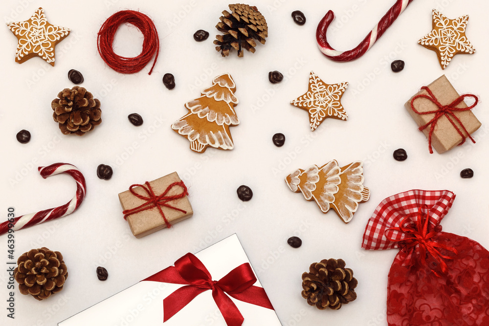Christmas pattern with lollipops, gingerbread and pine cones on a white background Christmas pattern with lollipops, gingerbread and pine cones on a white background