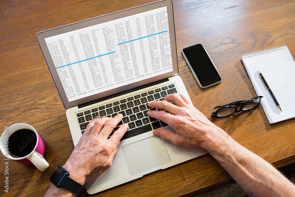 Fototapeta premium Hands of caucasian male programmer sitting at desk, using laptop with coding on screen
