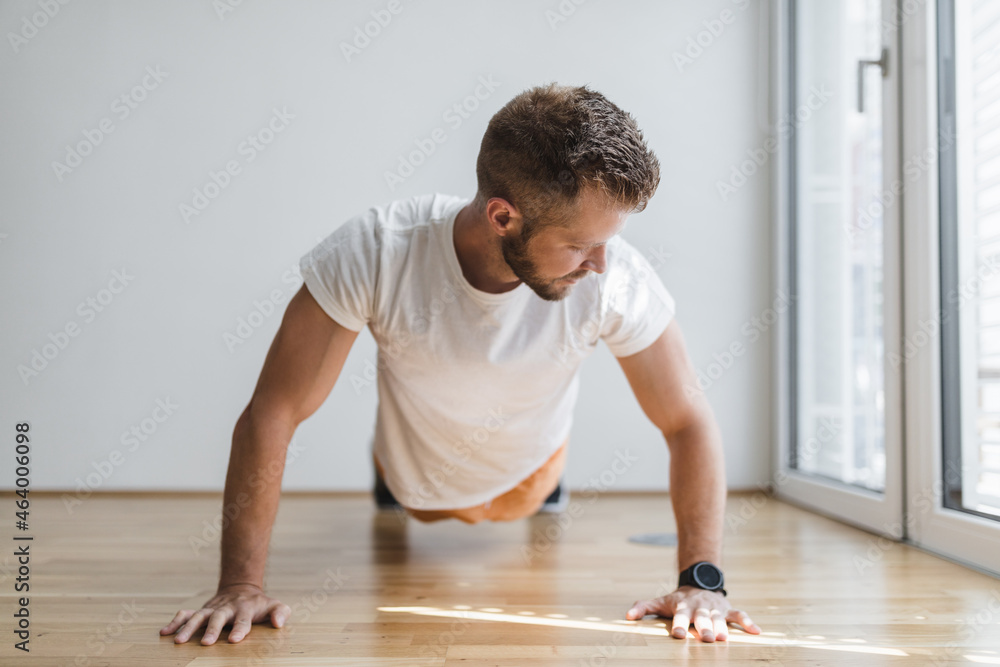 Handsome man working out at home Handsome man working out at home