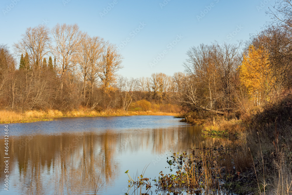 Beautiful landscape of a calm river against the backdrop of an autumn forest. Beautiful landscape of a calm river against the backdrop of an autumn forest.
