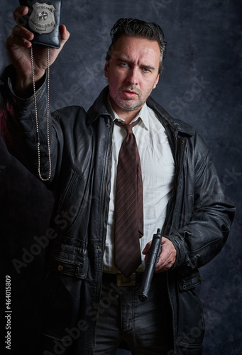 Police detective on a dark background, a policeman at work, tough cop, fake badge