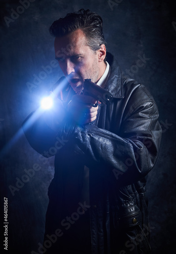 Police detective on a dark background, a policeman at work, tough cop, fake badge