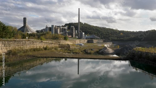 Abandoned Dutch Cement industry factory at chalk and limestone quarry in Limburg, the Netherlands with beautiful colored lake photo