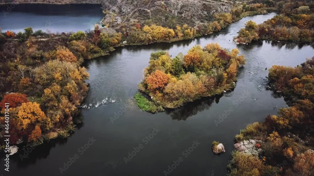 Aerial cinematic view of colorful autumn trees and blue river. drone shot. Aerial cinematic view of colorful autumn trees and blue river. drone shot.