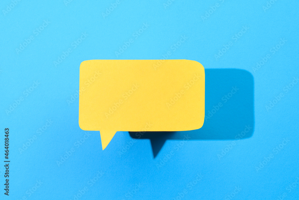 Yellow speech bubble on blue background Yellow speech bubble on blue background