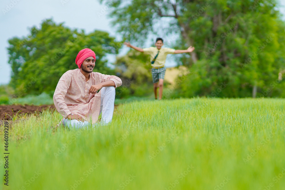 Indian farmer with his son at agriculture field. Indian farmer with his son at agriculture field.