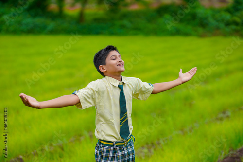 cute indian little school boy enjoying nature