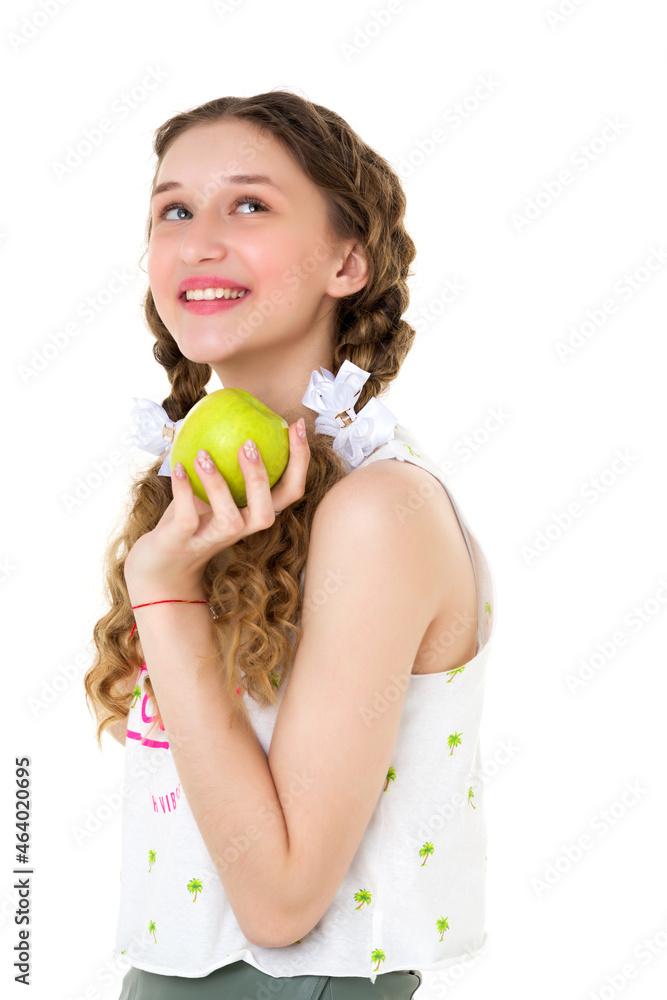 Smiling girl with two braids holding green apple Smiling girl with two braids holding green apple
