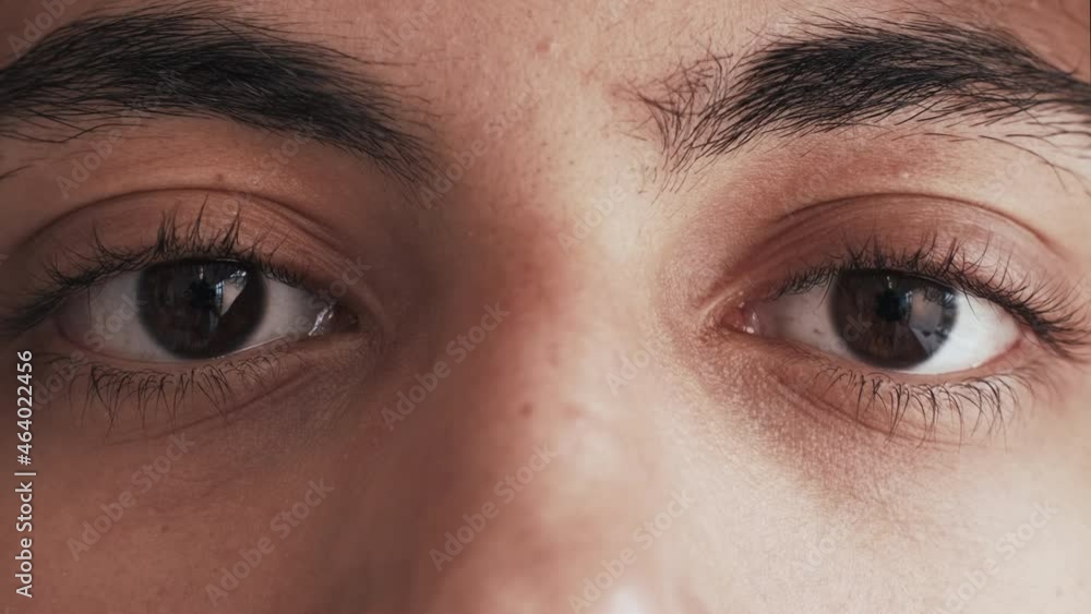 Ethnic tolerance. Diverse vision. Racial discrimination. Closeup of sad tired Arab man dark skin face open brown color eyes looking blinking motion.