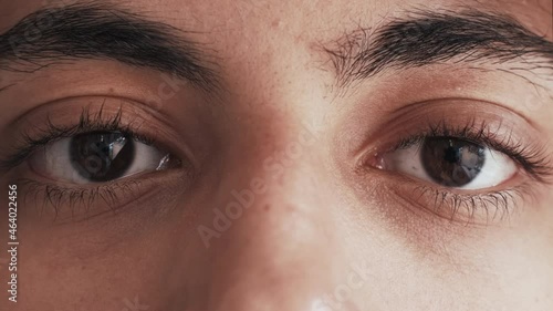 Ethnic tolerance. Diverse vision. Racial discrimination. Closeup of sad tired Arab man dark skin face open brown color eyes looking blinking motion.