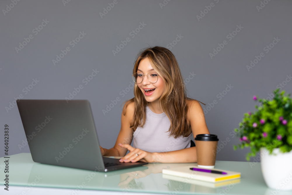 Portrait of young woman working with laptop in her office. Portrait of young woman working with laptop in her office.