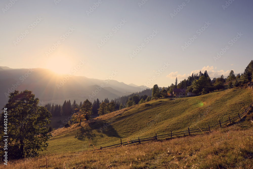 Morning sun shining over pasture in mountains Morning sun shining over pasture in mountains