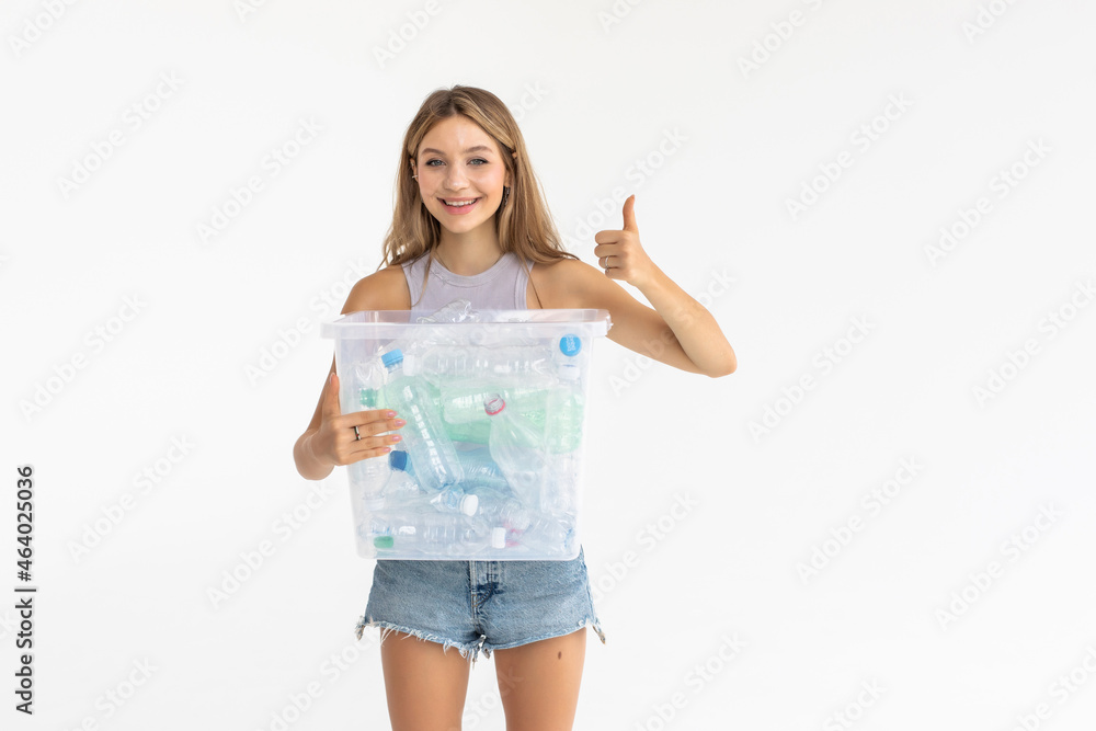 Smiling young woman holding full recycling box isolated on white background Smiling young woman holding full recycling box isolated on white background