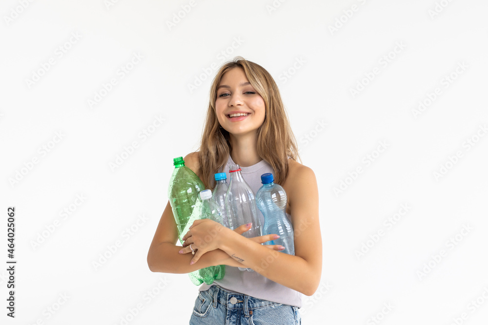 Young pretty woman carrying a plastic container full with empty recyclable plastic. Recycling concept Young pretty woman carrying a plastic container full with empty recyclable plastic. Recycling concept
