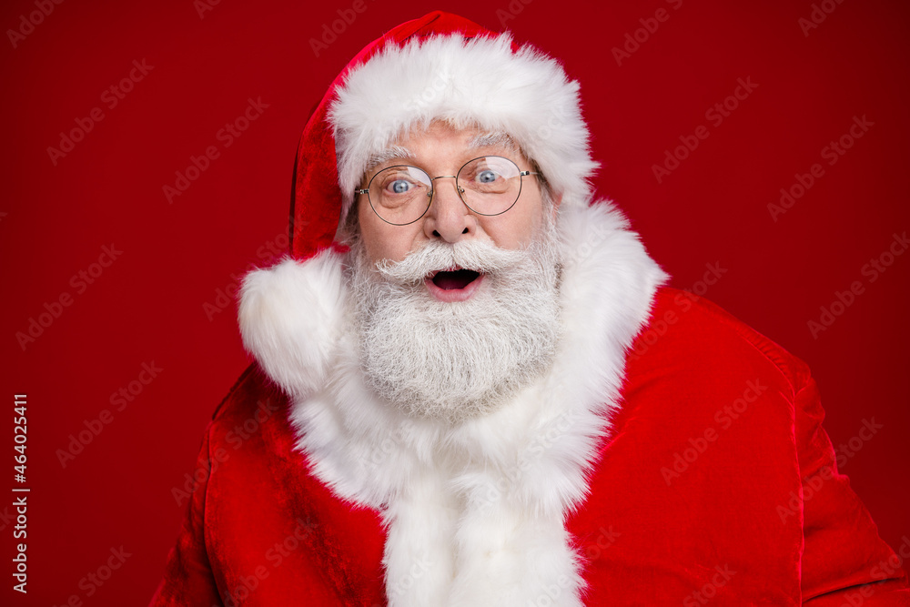 Photo of funny impressed retired man wear santa claus costume spectacles open mouth celebrating noel isolated red color background Photo of funny impressed retired man wear santa claus costume spectacles open mouth celebrating noel isolated red color background