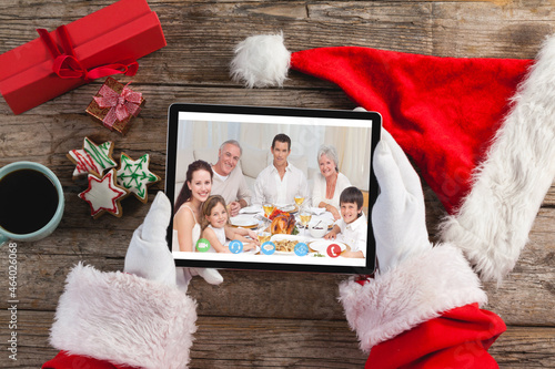 Santa claus making tablet christmas video call with smiling caucasian multi generation family