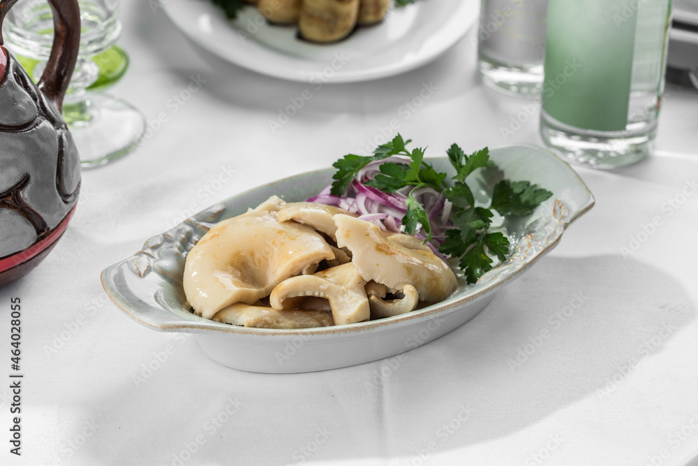 Pickled milk mushrooms with sour cream and chicken salad on the table Pickled milk mushrooms with sour cream and chicken salad on the table